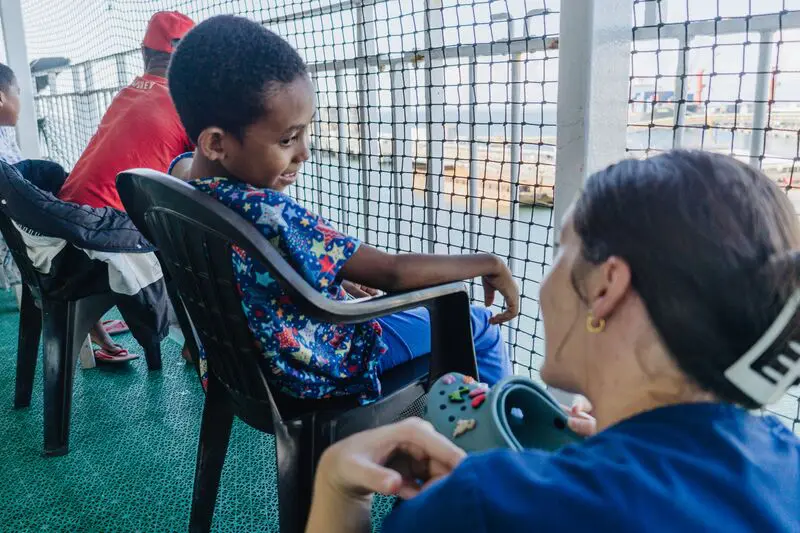 Joy Kim, Ward Nurse (Adult ICU), with a patient on International Nurses Day highlighting the great work Christian volunteers do abroad that aligns with their faith