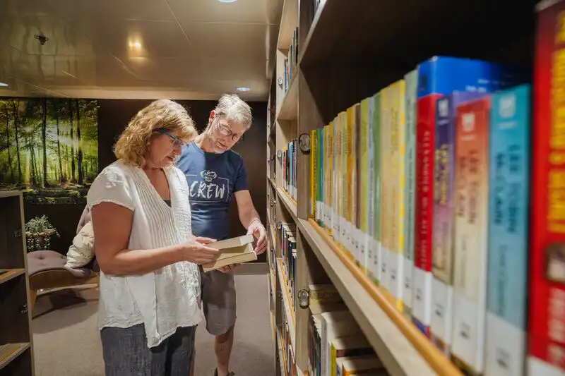 David Sigalet, Paediatric Surgeon, and Elaine Sigalet, ETA Simulation Coordinator, browsing the library onboard the Global Mercy.