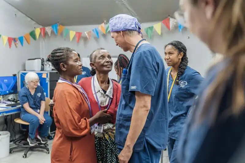 Marie Jeanne and Germaine, ophthalmic patients, during their first moments of seeing each other after their surgery.