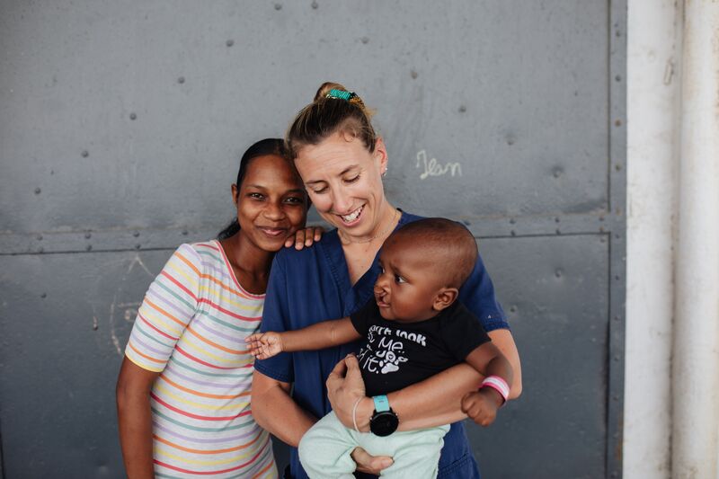 Kim-Maree Sherer, Clinical Dietician/Infant Feeding Coordinator, holding one of her dietician patients on his admission date.