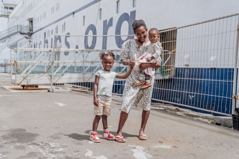 Tina, orthopaedics patient, on the dock at the end of her treatment to repair her clubfoot.