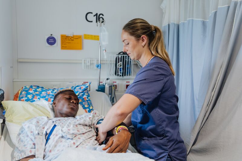 Sofie Espeland, Ward Nurse (Paediatric), with patients in the ward.
