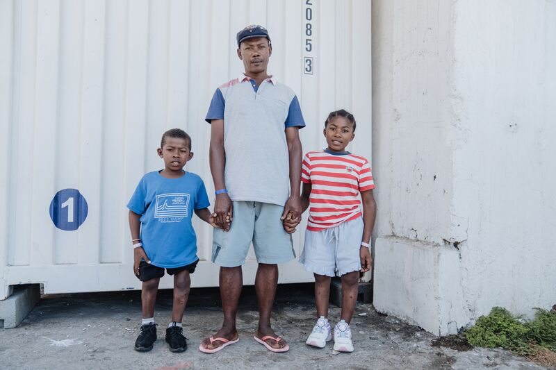 Siblings Elidiot and Arla, orthopaedics patient, on the dock on their day of their discharge with their father.