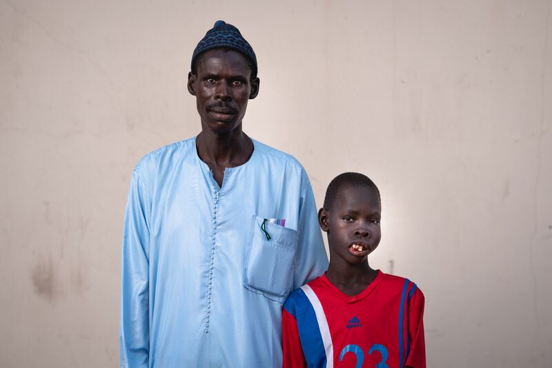 Mouhamed, maxillofacial patient, with his father before surgery.