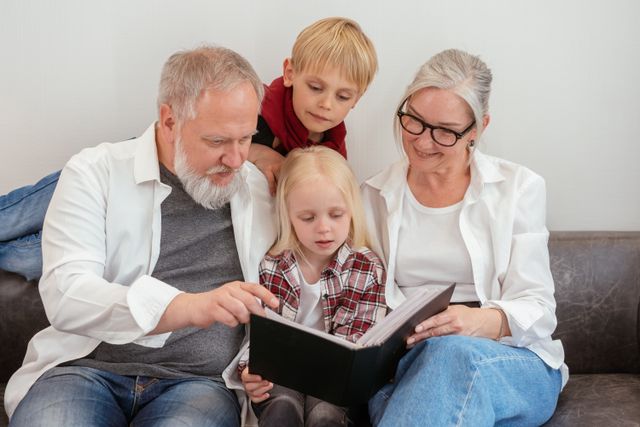 Grandparents and grandchildren looking at an album